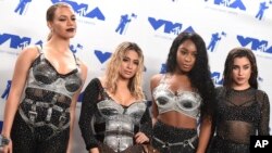 FILE - Dinah Jane, from left, Ally Brooke, Normani Kordei, and Lauren Jauregui of Fifth Harmony, winners of the award for best pop video for "Down," pose in the press room at the MTV Video Music Awards.