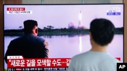 FILE - A man watches a TV showing a file image of a North Korea missile launch with leader Kim Jong Un looking on, during a news program at the Seoul Railway Station in Seoul, South Korea, Aug. 6, 2019.