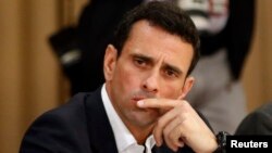 FILE - Venezuelan opposition leader Henrique Capriles attends a meeting with representatives of the opposition, the Roman Catholic Church and the Union of South American Nations (UNASUR) at Miraflores Place in Caracas, April 10, 2014. 