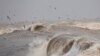 Seagulls fly over the rough sea as windy and stormy weather has been battering Italy, in Fiumicino near Rome.