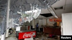 Broken glass is seen in a convenience store, after it was looted in Caracas, Venezuela, April 21, 2017. 