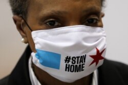 FILE Chicago Mayor Lori Lightfoot wears a mask at a news conference in Hall A of the COVID-19 alternate site at McCormick Place in Chicago, April 10, 2020. The "alternative care facility" is designed to relieve pressure on city hospitals.