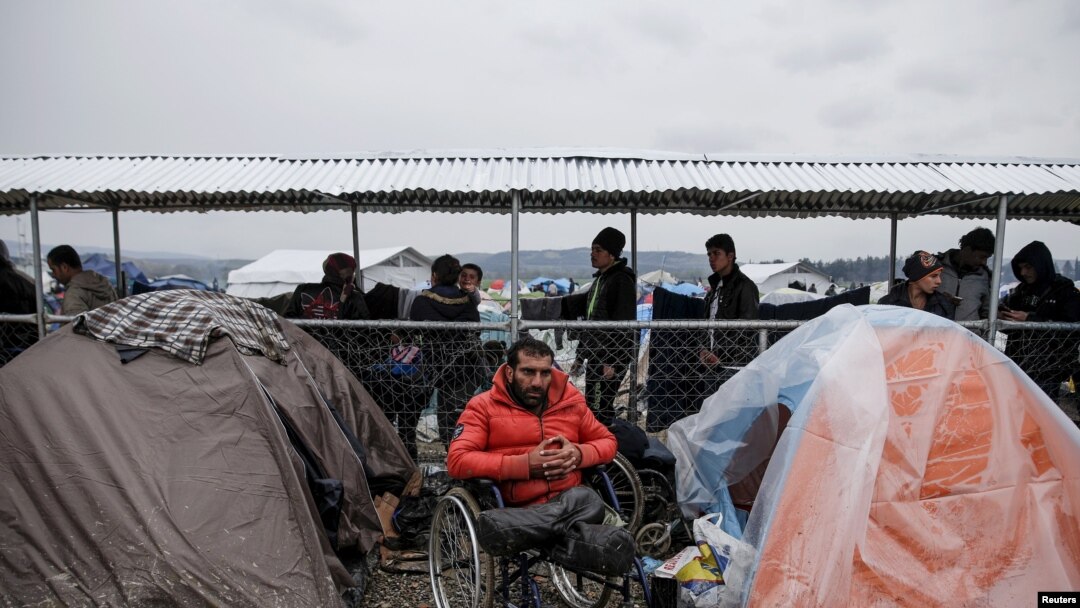 Syrian refugee Radwan Sheikho, 30, is seen among tents at a makeshift camp for refugees and migrants at the Greek-Macedonian border near the village of Idomeni, Greece, March 16, 2016.