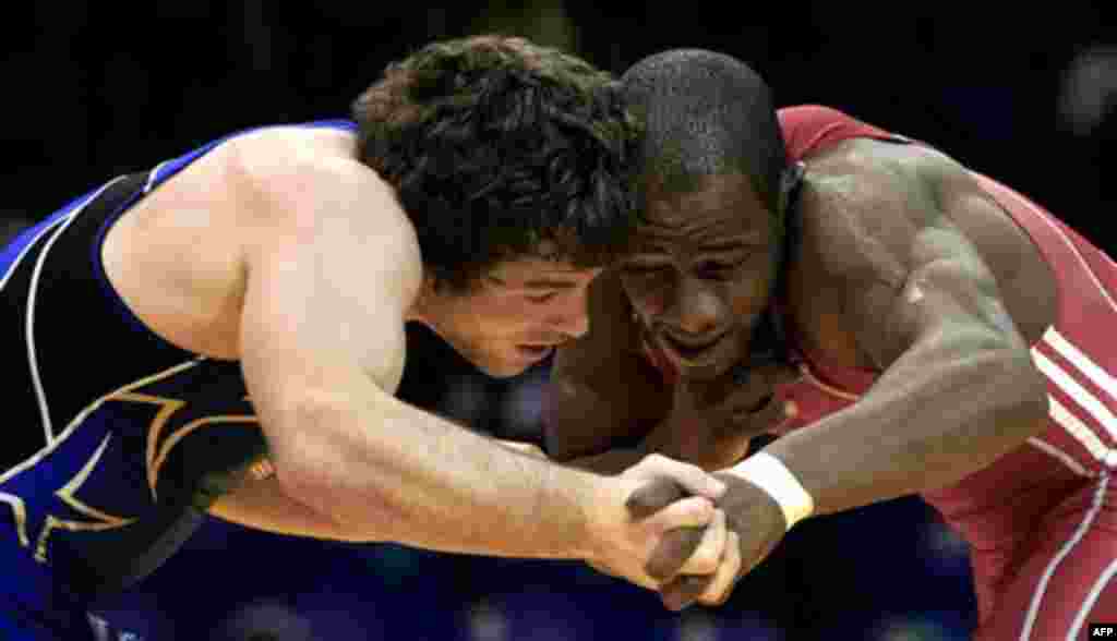 Cuba's Jorgisbell Alvarez, right, and Benjamin Provisor of the United States fight during a wrestling men's Greco-Roman 74kg final at the Pan American Games in Guadalajara, Mexico, Friday, Oct. 21, 2011. (AP Photo/Martin Mejia)