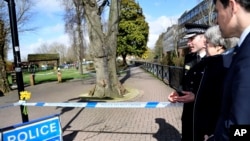 Britain's Prime Minister Theresa May is accompanied by Wiltshire Police Chief Constable Kier Pritchard and Salisbury MP John Glen, as she views the area where former Russian double agent Sergei Skripal and his daughter were found critically ill, in Salisb