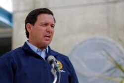 FILE - Florida Governor Ron DeSantis speaks to the media as Hurricane Dorian approaches the state, at the National Hurricane Center in Miami, Aug. 29, 2019.