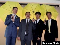 FILE - Joshua Wong (3rd-L) stands with, from left, Mark Lagon, then-president of Freedom House; Benny Tai, law professor in Hong Kong; and Martin Lee, founder of the Hong Kong Democratic Party, at a 2015 event in Washington. (Courtesy Freedom House)