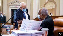 Rep. Bill Pascrell, D-N.J., left, and Rep. Danny Davis, D-Ill., confer as the tax-writing House Ways and Means Committee continues working on a sweeping proposal for tax hikes on big corporations and the wealthy, at the Capitol, Sept. 14, 2021.