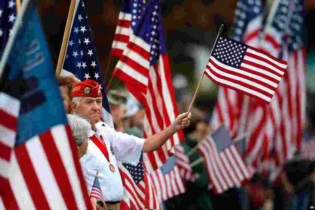 Former marine Charlie Paul joins hundreds who lined Main Street in Freeport, Maine, for a 9/11 remembrance event, Sept. 11, 2019. Paul, who served as a radio operator during the Vietnam War, attends the Freeport flag ladies' final flag-waving ritual.