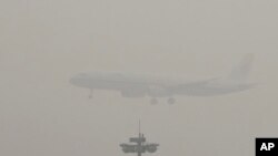 Pesawat penumpang milik maskapai penerbangan Air China bersiap melakukan pendaratan di bandara internasional ibukota Beijing, China saat kota itu diseliputi asap tebal akibat polusi, 21 Desember 2016 (Foto: dok). 