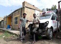 FILE - Eritrean nationals Goitom Tesfaye, 24, left, and Filimon Daniel, 23, are pictured at their garage in Mekele, Tigray region, Ethiopia, July 7, 2019.
