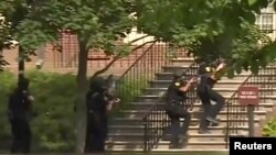 FILE - Police enter a building following a shooting at the municipal center in Virginia Beach, Va., May 31, 2019, in this still image taken from video.