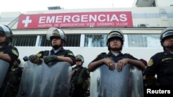 Police stand guard outside a hospital where Peru's former President Alan Garcia was taken after he shot himself, in Lima, Peru, April 17, 2019.