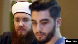 Islamic Central Council of Switzerland’s president, Nicolas Blancho, left, and multimedia chief Naim Cherni attend a news conference in Bern, Switzerland, Dec. 21, 2015. The Swiss attorney general has opened a criminal investigation of Cherni.