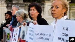 Founding member of the Ending Clergy Abuse organization, Denise Buchanan, right, and member Leona Huggins, second from right, participate in a protest outside the St. Anselm on the Aventine Benedictine complex in Rome, Feb. 22, 2019.