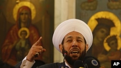 Syrian Mofti Ahmad Hassoun speaks during a mass prayer for the people and army soldiers who were killed during the violence around the country, at the Holy Cross Church, in Damascus, Syria. Thousands of Syrians attended special prayers held in Damascus fo