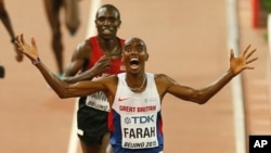 Mo Farah britannique célèbre après avoir remporté la médaille d'or lors de la finale masculine de 10.000m aux Championnats du monde d'athlétisme, à Pékin, le samedi 22 août 2015