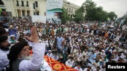 Khadim Hussain Rizvi, leader of Tehrik-e-Labaik Pakistan (TLP) Islamic political party, gestures as he addresses the supporters during a rally to express solidarity with the people of Kashmir, in Lahore, Pakistan, Aug. 9, 2019.