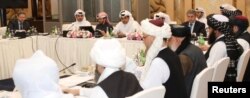 FILE - Undated handout picture of U.S., Taliban and Qatar officials during a meeting for peace talks in Doha, Qatar.