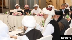 Undated handout picture of U.S., Taliban and Qatar officials during a meeting for peace talks in Doha, Qatar. 