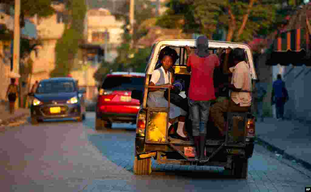 Students ride to school in a "tap-tap," a vehicled used for public transportation, in Port-au-Prince, Haiti.