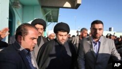 Anti-American cleric Muqtada al-Sadr, center, is surrounded by bodyguards in the Shiite city of Najaf, Iraq, 06 Jan 2011