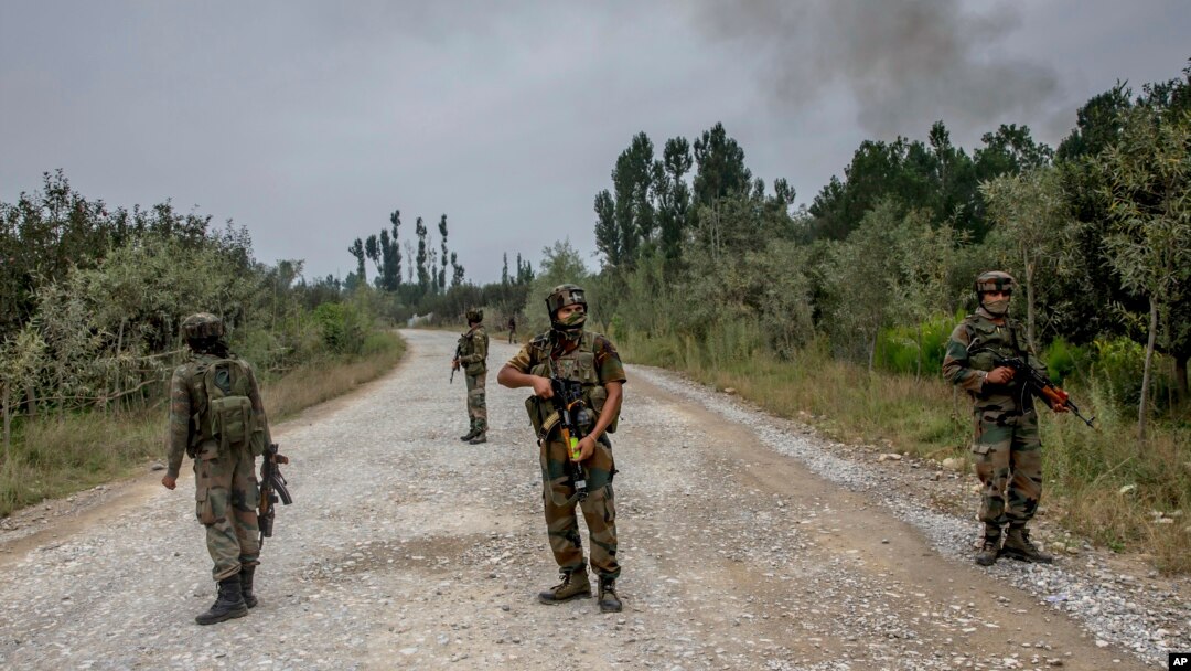 Indian army soldiers stand guard near the site of a gunbattle in Pulwama, about 35 kilometers south of Srinagar, in Indian-controlled Kashmir, Aug. 26, 2017.