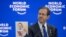 FILE - Israeli President Isaac Herzog shows a photograph of 10-month-old baby Kfir Bibas held by Hamas during a session of the World Economic Forum meeting in Davos on January 18, 2024.