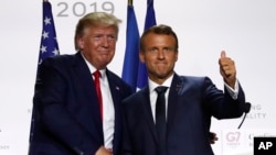 U.S President Donald Trump and French President Emmanuel Macron shake hands after their joint press conference at the G7 summit Monday, Aug. 26, 2019 in Biarritz, southwestern France. 