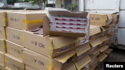 FILE - Cartons of counterfeit cigarettes are seen before being destroyed in Durban, June 24, 2011. 