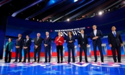 FILE - Democratic U.S. presidential candidates before the start at the 2020 Democratic U.S. presidential debate in Houston, Sept. 12, 2019.