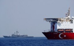 FILE - The Turkish drilling vessel Yavuz is seen being escorted by a Turkish navy frigate in the eastern Mediterranean off Cyprus, Aug. 6, 2019.