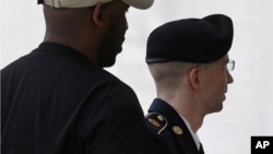 Army Pfc. Bradley Manning, right, is escorted into a courthouse in Fort Meade, Maryland, July 29, 2013, as military judge Col. Denise Lind begins her third day of deliberations in his court martial. 