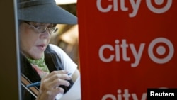 A woman fills out an application for one of the 300 available positions at a new Target retail store in San Francisco, California, August 9, 2012. 