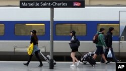 People walk on a platform to take a train, at the Saint-Charles railway station, in Marseille, southern France, June, 1, 2016. 