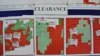 FILE - Maps indicating the progress of UXO technical surveys and clearance operations are displayed in Phonsavan, Laos, Nov. 1, 2019. (Zsombor Peter/VOA)