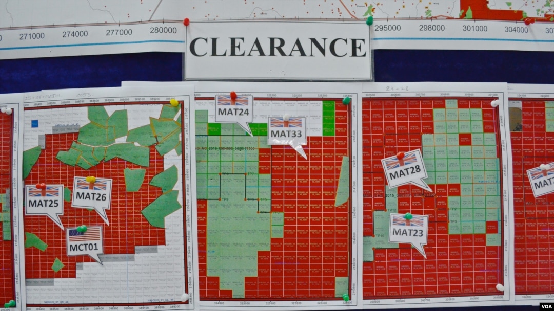 FILE - Maps indicating the progress of UXO technical surveys and clearance operations are displayed in Phonsavan, Laos, Nov. 1, 2019. (Zsombor Peter/VOA)