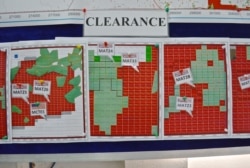 Maps indicating the progress of UXO technical surveys and clearance operations are displayed at the MAG office in Phonsavan, Nov. 1, 2019. (Zsombor Peter/VOA)