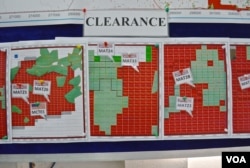 Maps indicating the progress of UXO technical surveys and clearance operations are displayed at the MAG office in Phonsavan, Nov. 1, 2019. (Zsombor Peter/VOA)