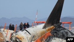 Investigators from South Korea and the U.S. inspect the scene where a Jeju Air Boeing 737-800 aircraft crashed and burst into flames at Muan International Airport, in Muan, South Korea, Dec. 31, 2024.