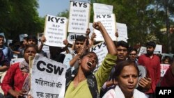 FILE - Indian activists and students hold placards and shout slogans during a protest against the alleged political silence over the rape of a child near Jammu and a rape case in Uttar Pradesh state, in New Delhi, April 12, 2018. 