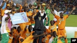 Ivory Coast players celebrate with the trophy after winning their African Football Cup of Nations final against Ghana in Bata, Equatorial Guinea, Feb. 8, 2015. The tournament returns to Gabon for the second time in five years beginning Jan. 14, 2017.