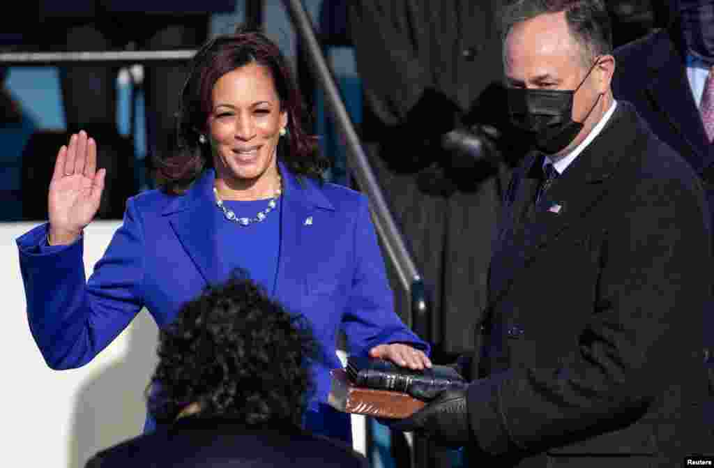 Kamala Harris is sworn in as Vice President as her spouse Doug Emhoff holds a bible during the 59th Presidential Inauguration at in Washington, Jan. 20, 2021.