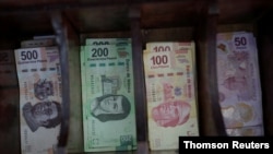 ARCHIVO - Billetes de pesos mexicanos en una casa de cambio de moneda en Ciudad de México.