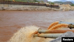 FILE - Water gushes out from pipes by the construction of Ethiopia's Great Renaissance Dam in Guba Woreda, some 40 kilometers from Ethiopia's border with Sudan.