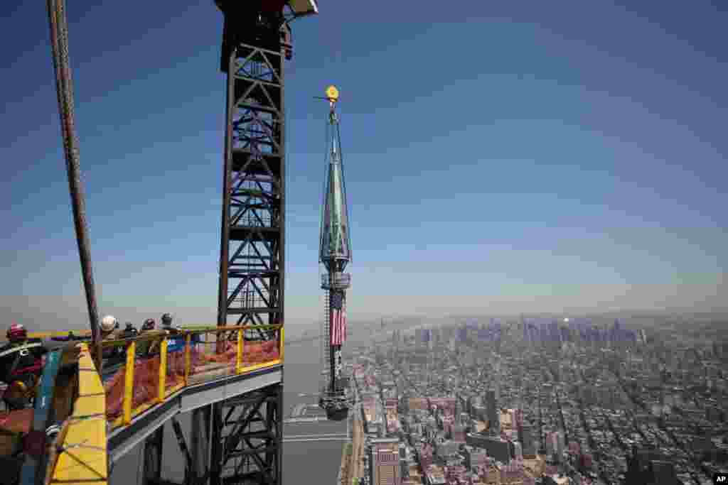 One of the last two segments of the spire is hoisted to the top of One World Trade Center, May 2, 2013.