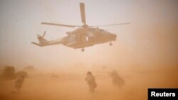 FILE - A NH 90 Caiman military helicopter takes-off during the regional anti-insurgent Operation Barkhane in Inaloglog, Mali.