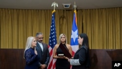 Justice Secretary Wanda Vazquez is sworn in as governor of Puerto Rico by Supreme Court Justice Maite Oronoz, in San Juan, Aug. 7, 2019. Vazquez was joined by her daughter Beatriz Diaz Vazquez and her husband Judge Jorge Diaz. 