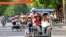 Khách du lịch Trung Quốc đi xích lô ở Hà Nội. Khách từ quốc gia láng giềng phương Bắc tới Việt Nam tăng gần 50% so với năm trước, chiếm gần 1/3 lượng khách quốc tế tới Việt Nam trong năm nay.