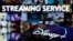 FILE PHOTO: A smartphone screen showing the "Disney+" logo is seen in front of the words "streaming service" in this illustration